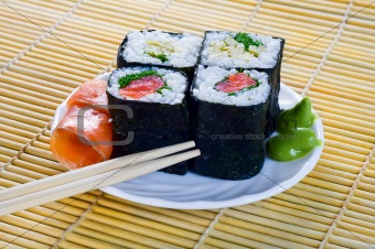 4 rolls of sushi with fish
