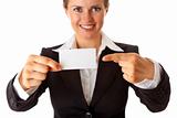 smiling modern business woman pointing finger on blank business card
