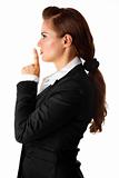 modern business woman with finger at mouth. shh gesture
