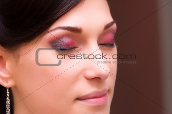 brunette young lady closeup prepared by makeup artist