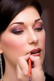 closeup brunette young lady get ready for the event by makeup ar