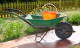 gardener green wheel barrow with orange pail
