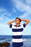 boy teenager hands in head relaxed in blue ocean