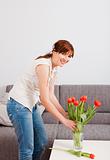 Woman at home holding flowers