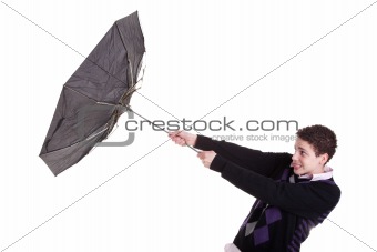 Young boy with an umbrella turned by the wind, isolated on white, studio shot