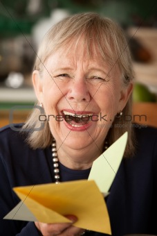 Senior woman with greeting card