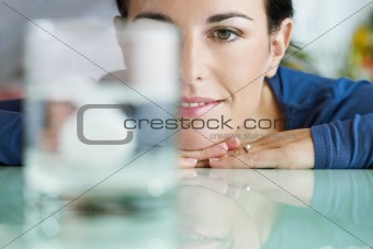 woman looking at aspirin in glass of water