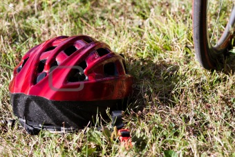 Red helmet lying on the grass