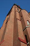 towering brick church steeple against blue sky