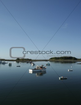 Quiet Maine harbor with lobster boats