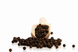 black peppercorns from a small wooden shovel front