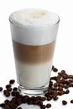 latte macchiato with coffee beans on white