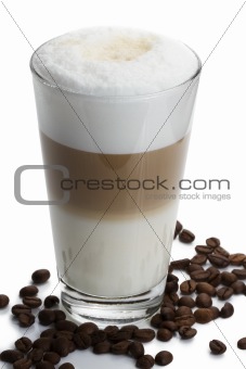 latte macchiato with coffee beans on white
