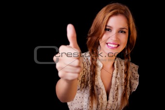 Young pretty women with thumb raised as a sign of success, thumbs up, isolated on black, studio shot