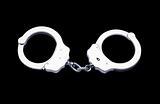 Metal handcuffs isolated on the black background 