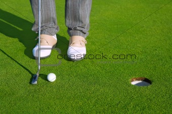 Golf green hole course man putting short ball