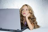 Student little school girl on laptop compute