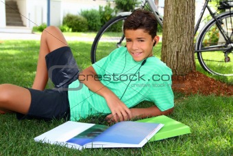 Teen smiling boy studying book garden headphones