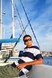 boy relaxed teenager on boat marina summer vacation
