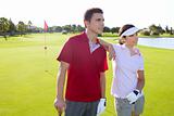 Golf course young players couple standing
