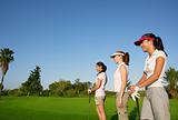 Golf three woman in a row green grass course