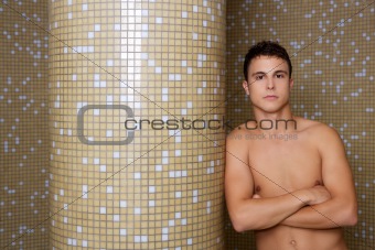 sexy man crossed arms in tiled background