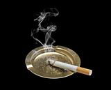 Cigarette and ashtray isolated on black background