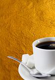 Cup of coffee over gold background
