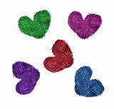 textile hearts over white background
