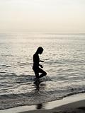 Silhouette of young girl in the sea