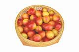 Plums in the braided basket isolated on white background