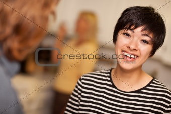 Laughing Young Woman Socializing in a Party Setting.