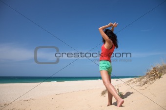 red shirt woman dancing at the beach