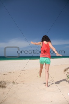 shorts woman jumping on sand