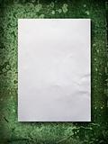 Blank paper on old green wall
