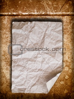 Crumpled paper on old wall