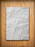 Crumpled paper on wood wall