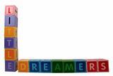 little dreamers on toy letter blocks on white