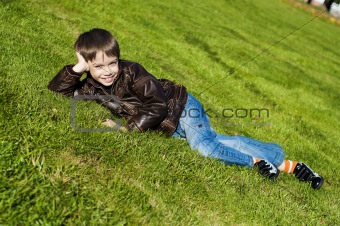 Little boy Lying Down on the  grass