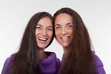 two sisters with very long brown hair standing smiling