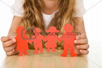 Family concept with little girl holding paper people