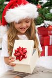 Little girl opening christmas present