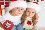 Christmas kids with santa hats and presents