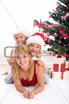 Happy people in front of christmas tree