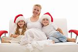Woman with kids sitting on a sofa at christmas time