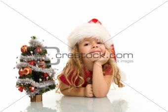 Little girl with small christmas tree