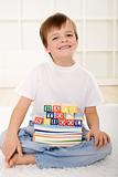 Happy kid with school books sitting on the floor