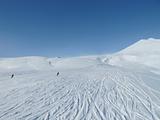 Skiers on wide open piste in French alps