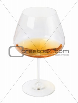 Glass of brandy (cognac) isolated on a white background