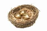 Three golden hen's eggs in the bird's nest isolated on white